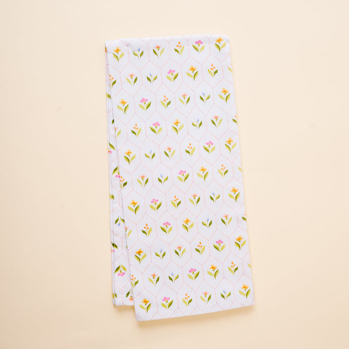 The-darling-effect's Handpicked For You Tea Towel is a neatly folded white cotton towel with small yellow and pink flowers and green leaves, shown on a light beige background.
