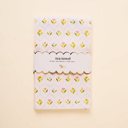 The-darling-effect’s Handpicked For You Tea Towel features a folded cotton design with a yellow, pink, and green floral pattern, wrapped in a scalloped “tea towel” label—an ideal kitchen accent.