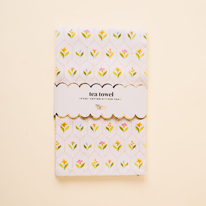 The Handpicked For You Tea Towel by the-darling-effect features a yellow and pink floral pattern on white cotton, wrapped in a scalloped label reading "tea towel" and "Egypt’s cotton kitchen towel." It adds an elegant touch to any home.