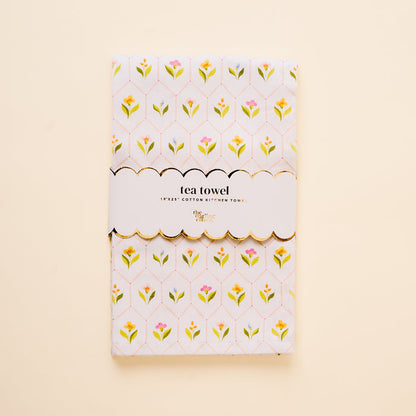 The Handpicked For You Tea Towel by the-darling-effect features a yellow and pink floral pattern on white cotton, wrapped in a scalloped label reading "tea towel" and "Egypt’s cotton kitchen towel." It adds an elegant touch to any home.