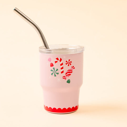 The Sugar Rush 2 oz Tiny Tumbler by The Darling Effect is a festive holiday mini tumbler in pink, adorned with charming candy cane and peppermint designs on a light beige background, and comes with a clear lid and metal straw.